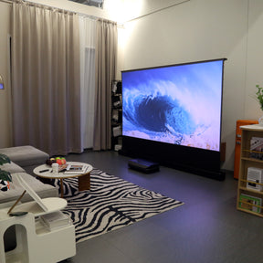 Dynamic ocean wave displayed on an AWOL Vision projector screen, showcasing powerful ALR screen capabilities in a stylish living room.
