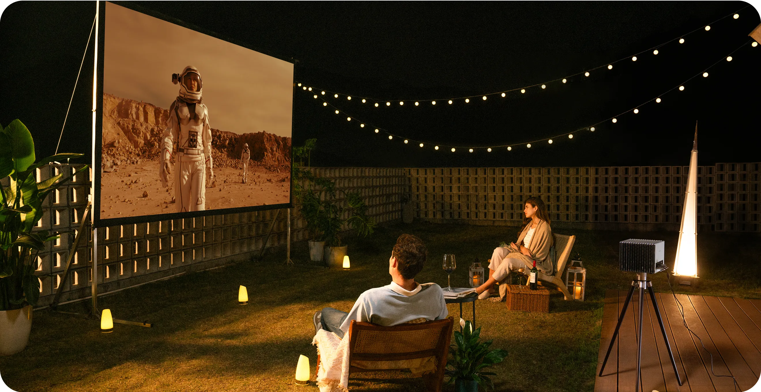 Valerion StreamMaster Plus 2 projector used for outdoor movie night in backyard setup.