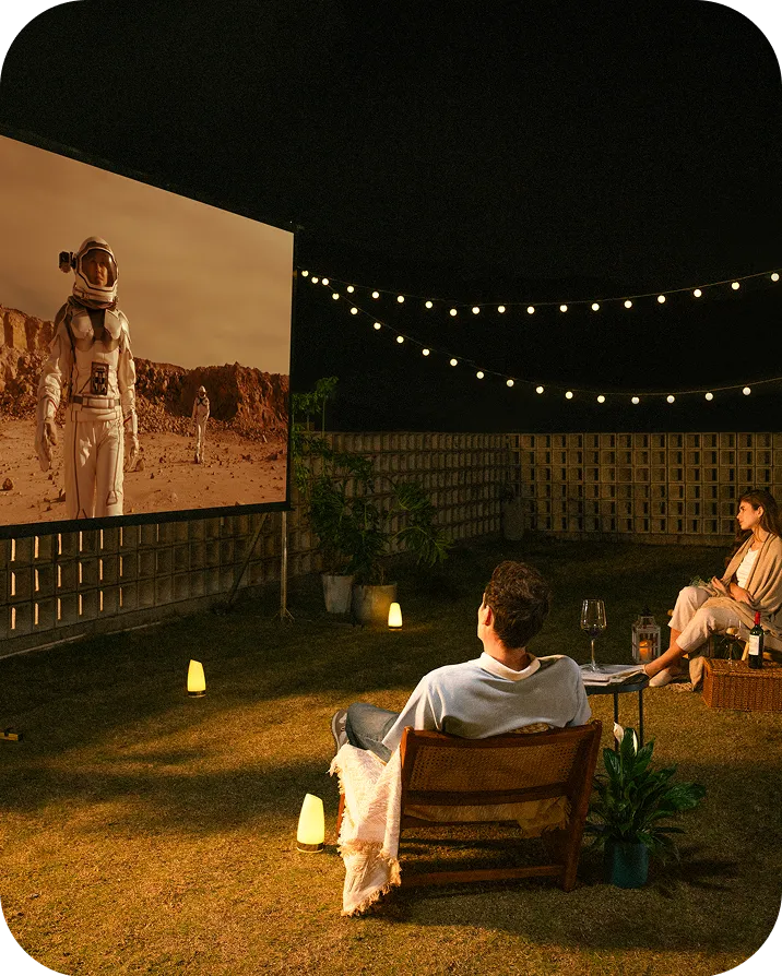 Valerion StreamMaster Plus 2 projector used for outdoor movie night in backyard setup.